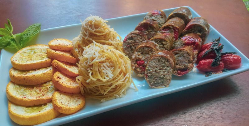 Pistachio Pesto Sausage served with capellini, roasted squash, and tomato.