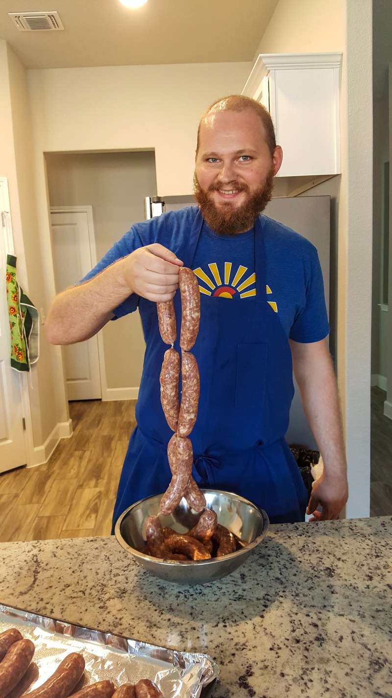 Keenan holding up sausages.